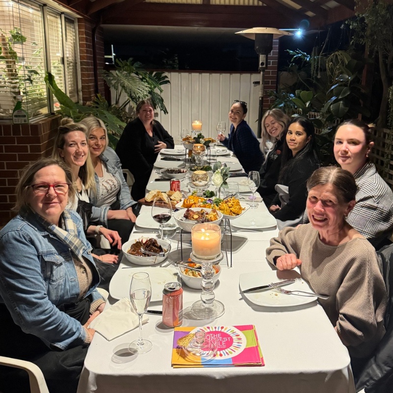 alt='TLT-Host large group friends sitting at the table'