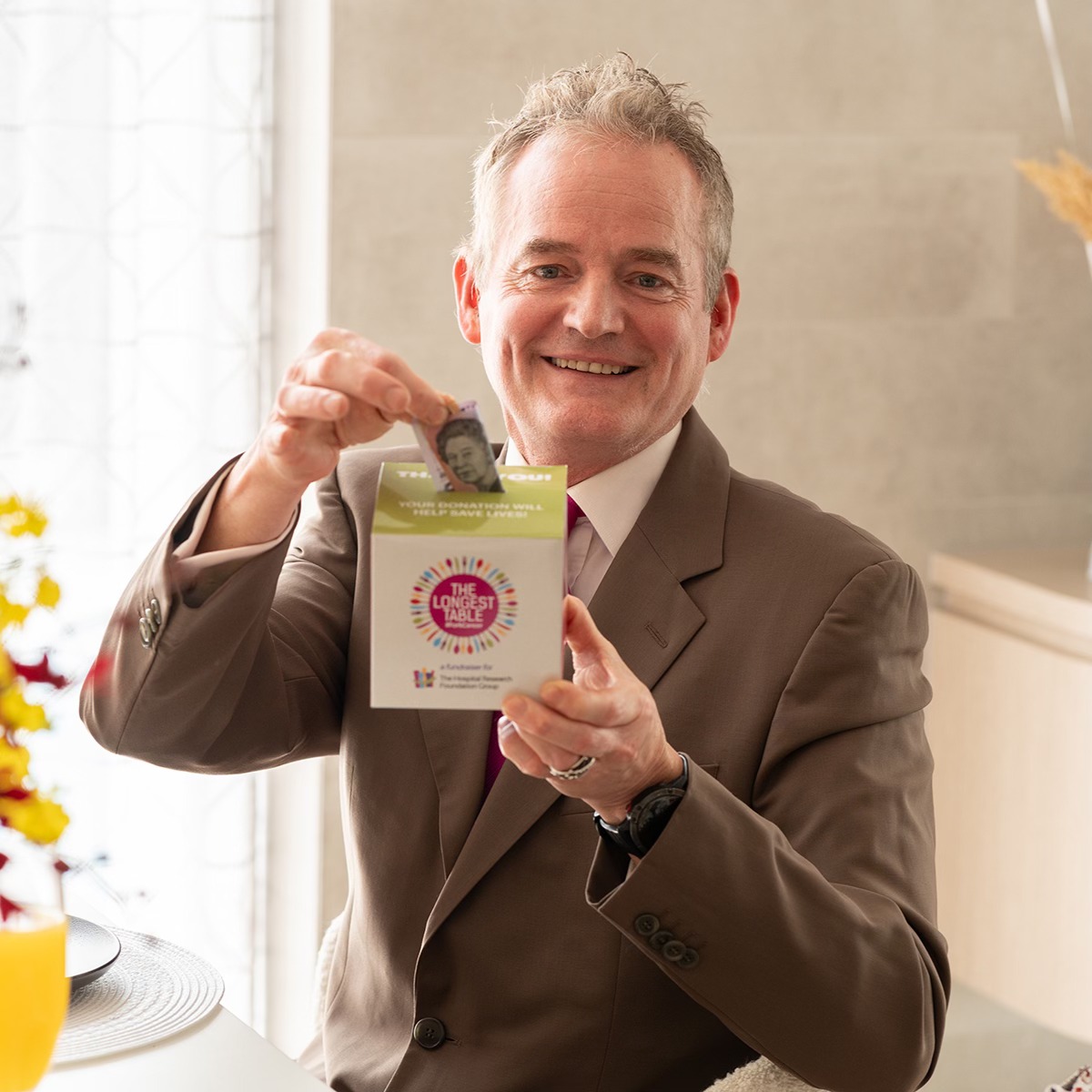 Ambassador Brenton Jolly donating using donation box