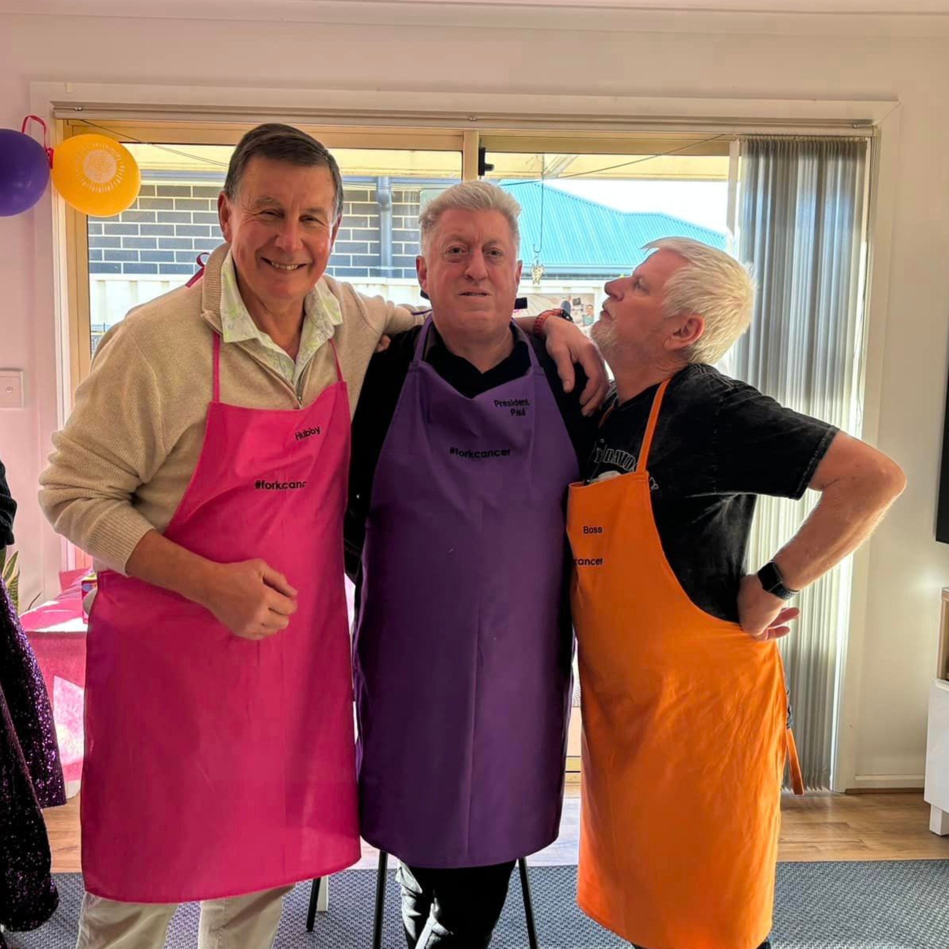 3 men wearing aprons for a barbecue